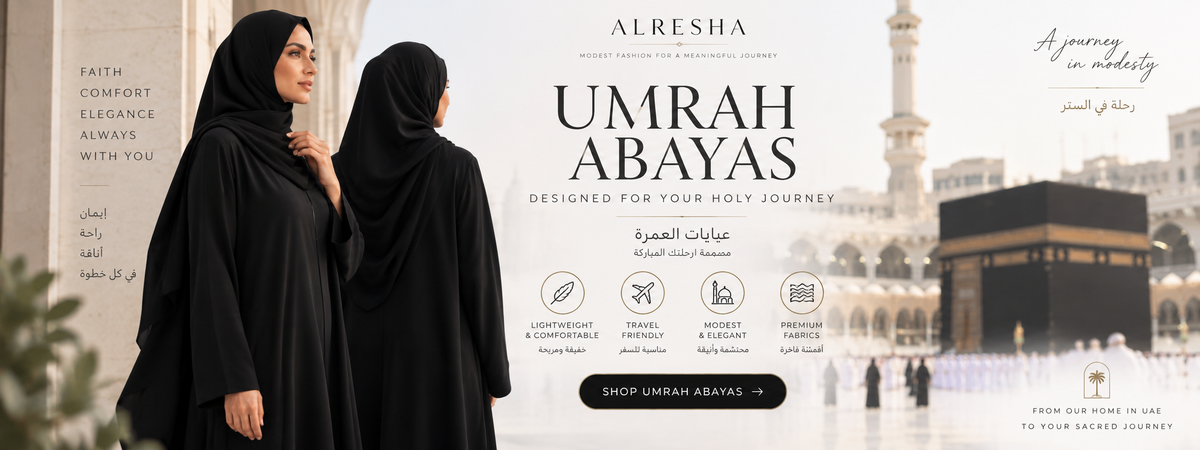  'Alresha Umrah Abayas', showing two women in black hijabs and abayas standing in front of the Kaaba in Mecca. The right side features text reading 'UMRAH ABAYAS' and 'ALRESHA', along with icons for lightweight, comfortable, and elegant travel clothing, and a black shopping button.